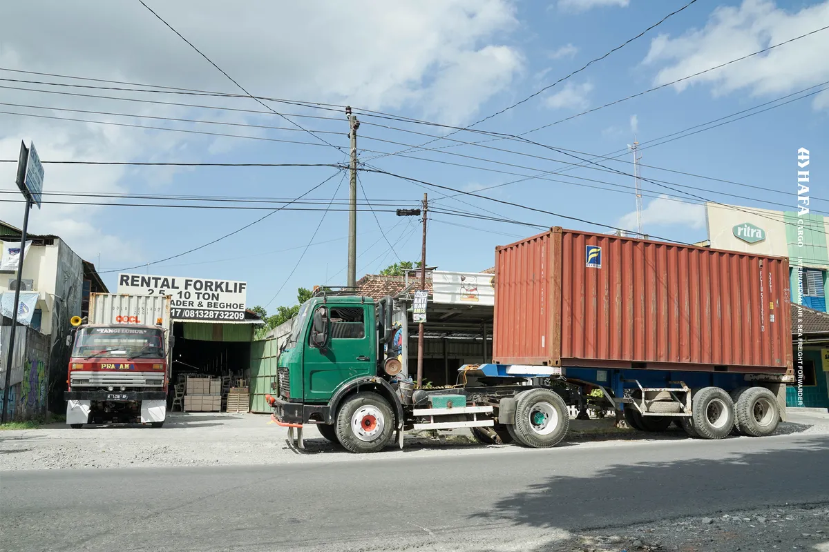 A truck carrying a shipping container outside the HAFA Cargo warehouse.