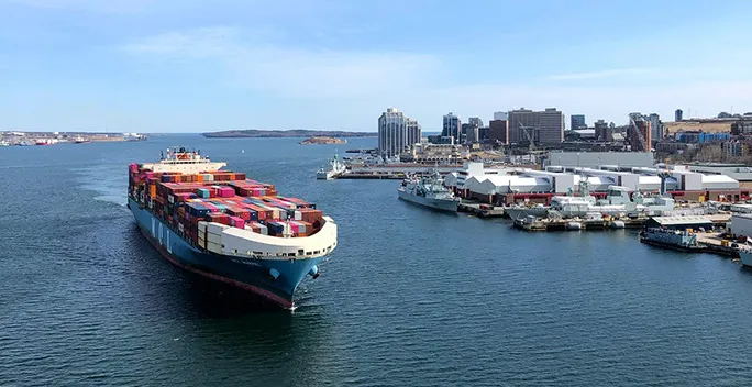 A container ship leaving a harbour.