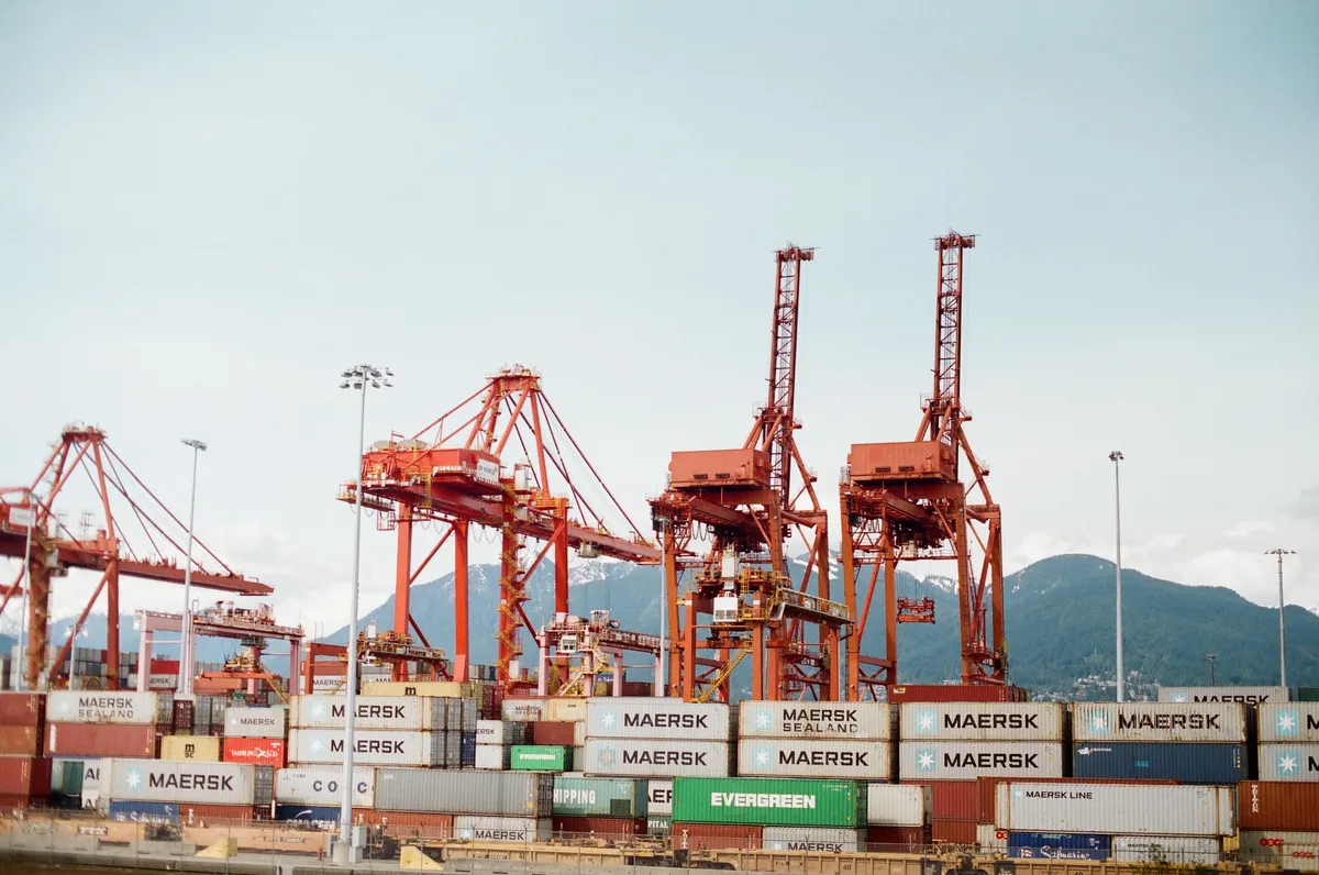 Container cranes and stacked containers at a port.